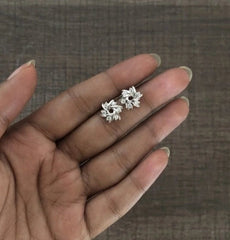 1 cm diameter six cz stone twisted flower studs in pure silver