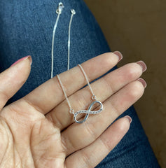 Infinity pattern pendant with cz stones and an 18’’ thin chain in pure silver