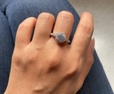 Compact round halo ring with a half studded band in pure silver