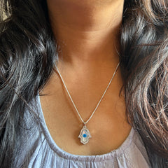 Hamsa pendant with cz stones and an 18’’ chain in pure silver