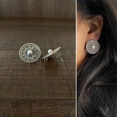 2.5 cm diameter rava work studs with a pearl center in pure silver