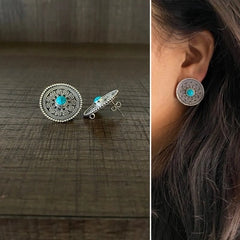 2.5 cm diameter rava work studs with a turquoise stone center in pure silver