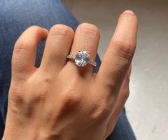 Oval cz ring with a half studded band in pure silver