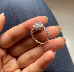 Compact round halo ring with a half studded band in pure silver