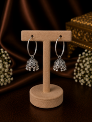 Light weight carving work jhumkas hanging from 3 cm thick plain balis in pure silver