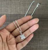 1cm diameter four cz stone pendant with an 18’’ chain in pure silver