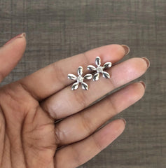 Flat flower studs with a single cz stone crafted in pure silver