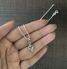 Mini musical note pendant with multiple cz stones with an 18 inch chain in pure silver