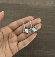 Oval rava work pearl center loops in pure silver