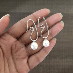 Spiral earrings crafted in pure silver with round pearl drops