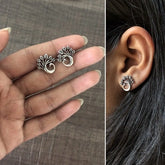 Curved peacock studs in pure silver with an antique finish