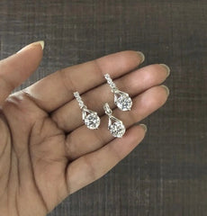 Four cz stone studs along with a matching 8mm cz pendant set in pure silver