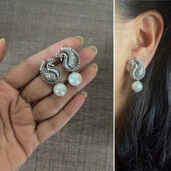 Small size antique finish peacock studs with pearl drops in pure silver