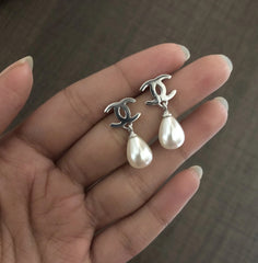Opposite 'C' pattern studs with shell pearl drops set in pure silver