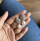 Uneven cz cut stone studs with pearl drops in pure silver