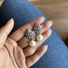 Uneven cz cut stone studs with pearl drops in pure silver