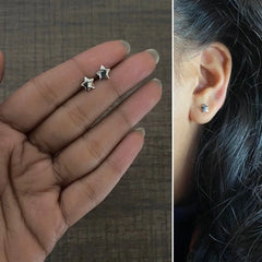 Small curved star studs in pure silver