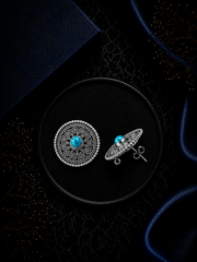 2.5 cm diameter rava work studs with a turquoise stone center in pure silver