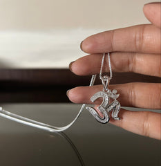 Om shape multi cz studded baguette setting pendant with an 18inch chain in pure silver