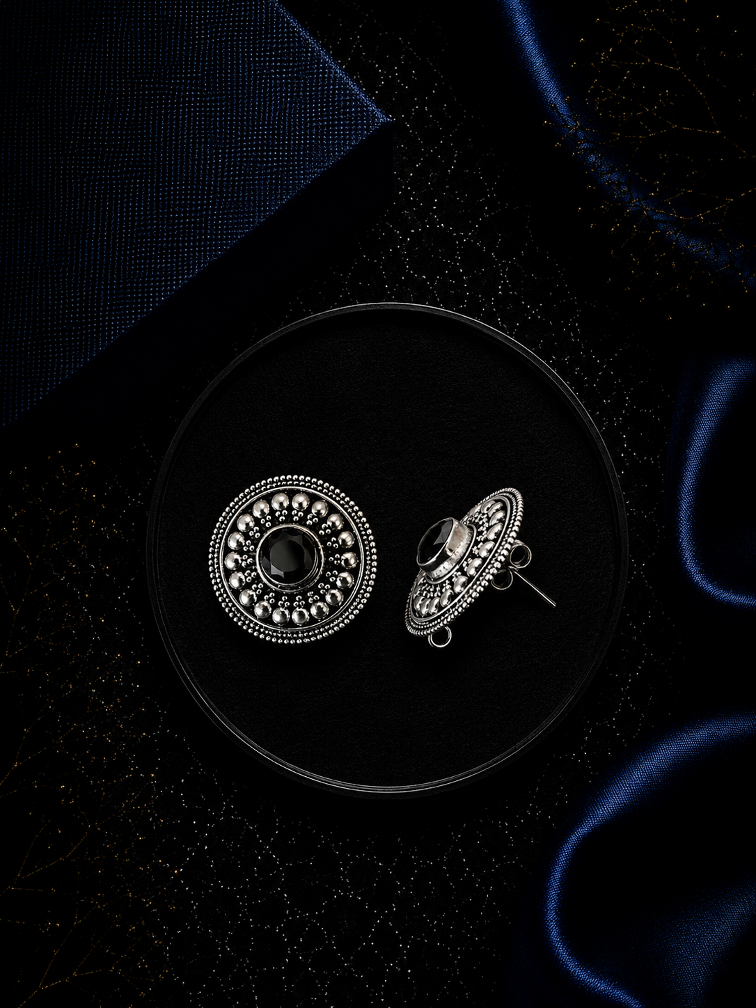 2.1 cm diameter carving rava work studs with a black onyx cut stone center in pure silver