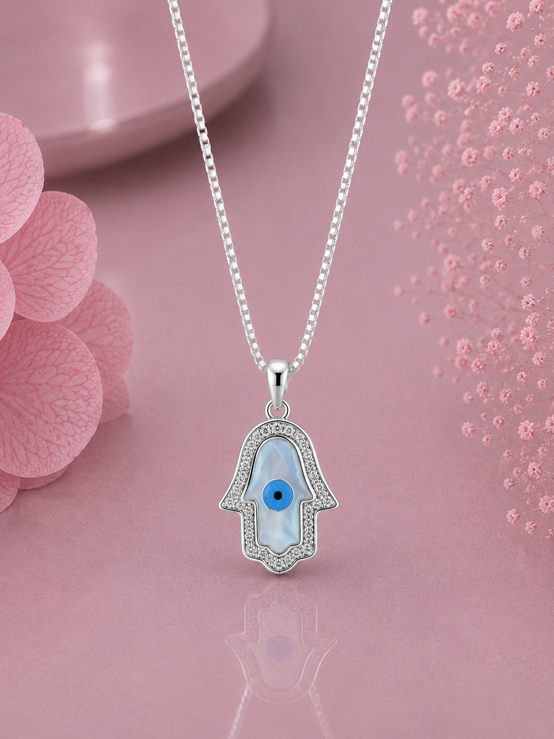 Hamsa pendant with cz stones and an 18’’ chain in pure silver