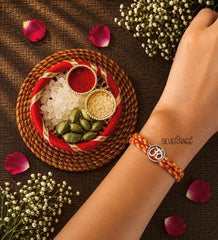 Silver Om with round rava border motif rakhi